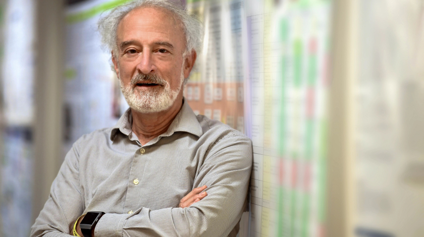 older man leaning on wall