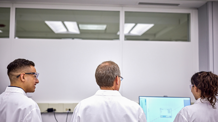three scientist looking at monitor
