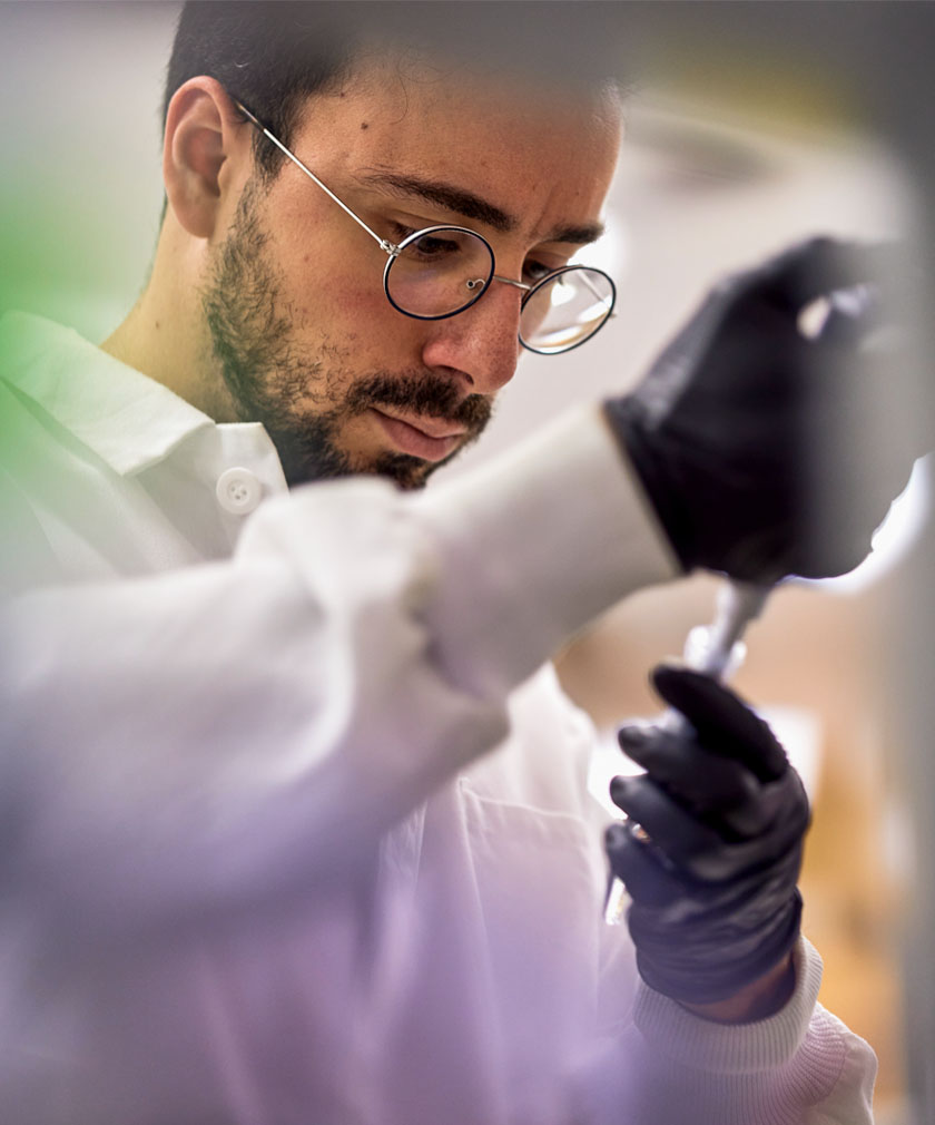 man looking at pipette